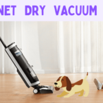 a child on the floor with dog and a vacuum